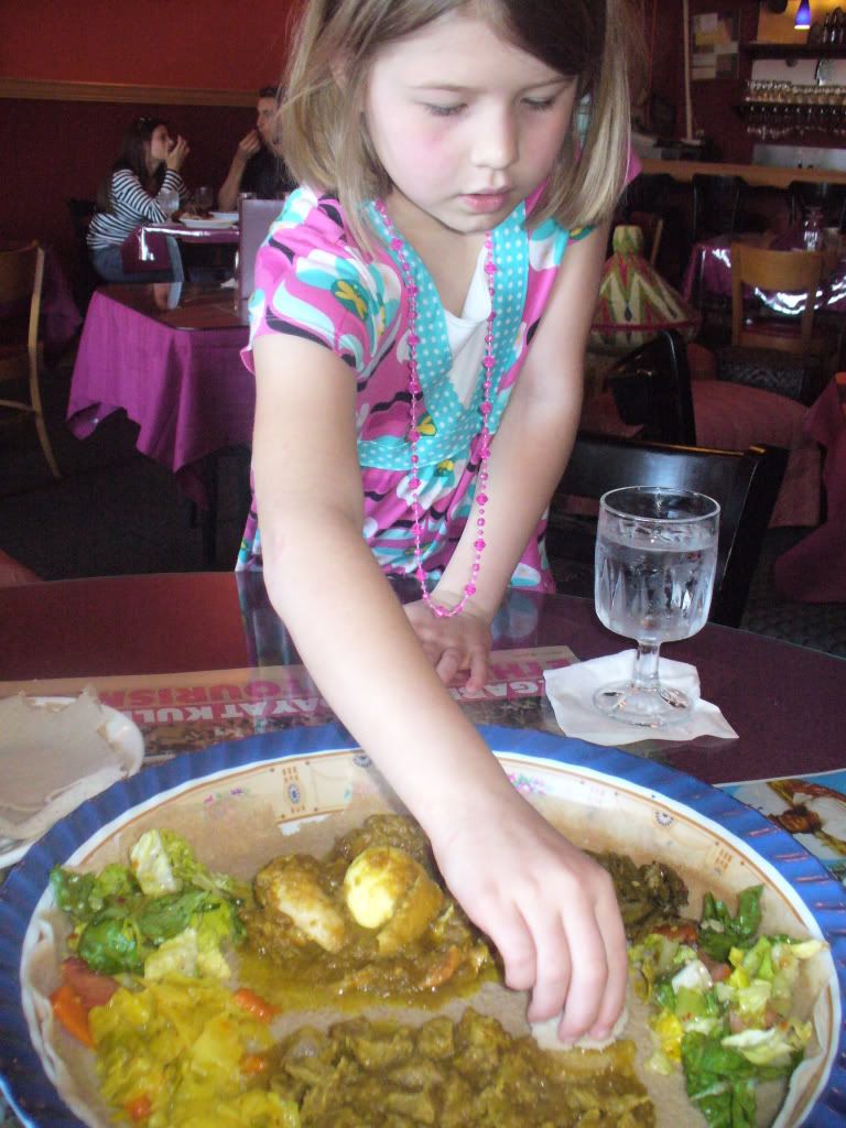 Aly eating Ethiopian food with injera