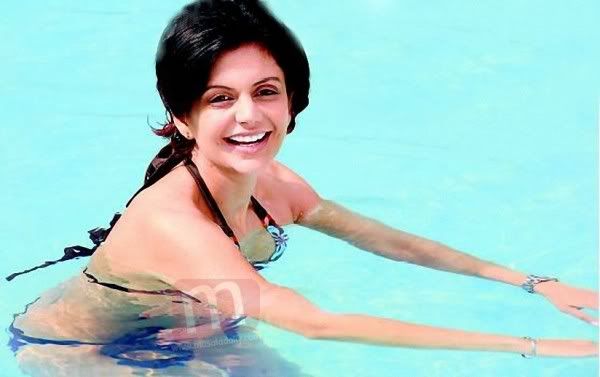 Mandira Bedi beats the heat in a bikini at the pool (new picture)...