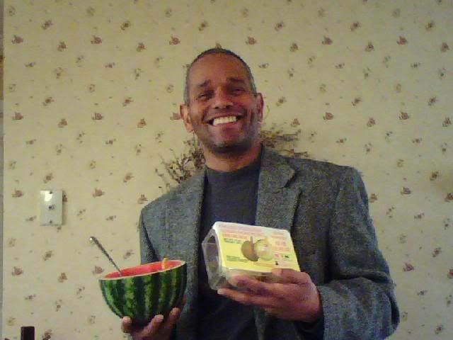 Todd raw remnant, holding half a watermelon and a box of durian